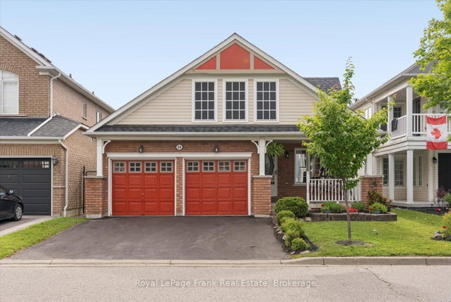Detached Ajax home with two red garage doors