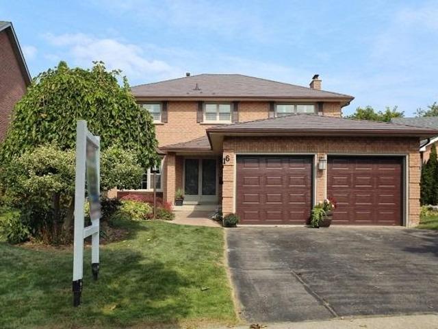 Detached Ajax home with two brown garage doors