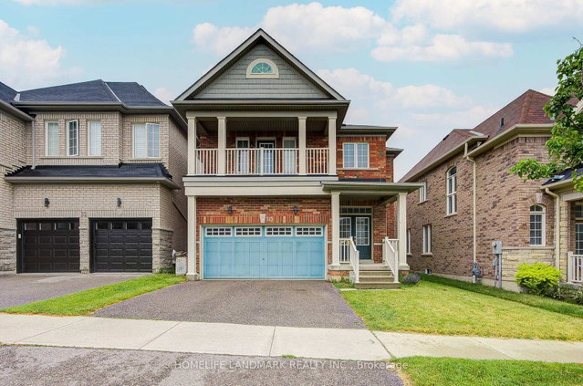 Detached Ajax home with two black garage doors