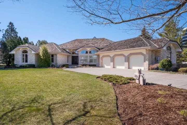 Garage doors with coordinated windows and decorative hardware