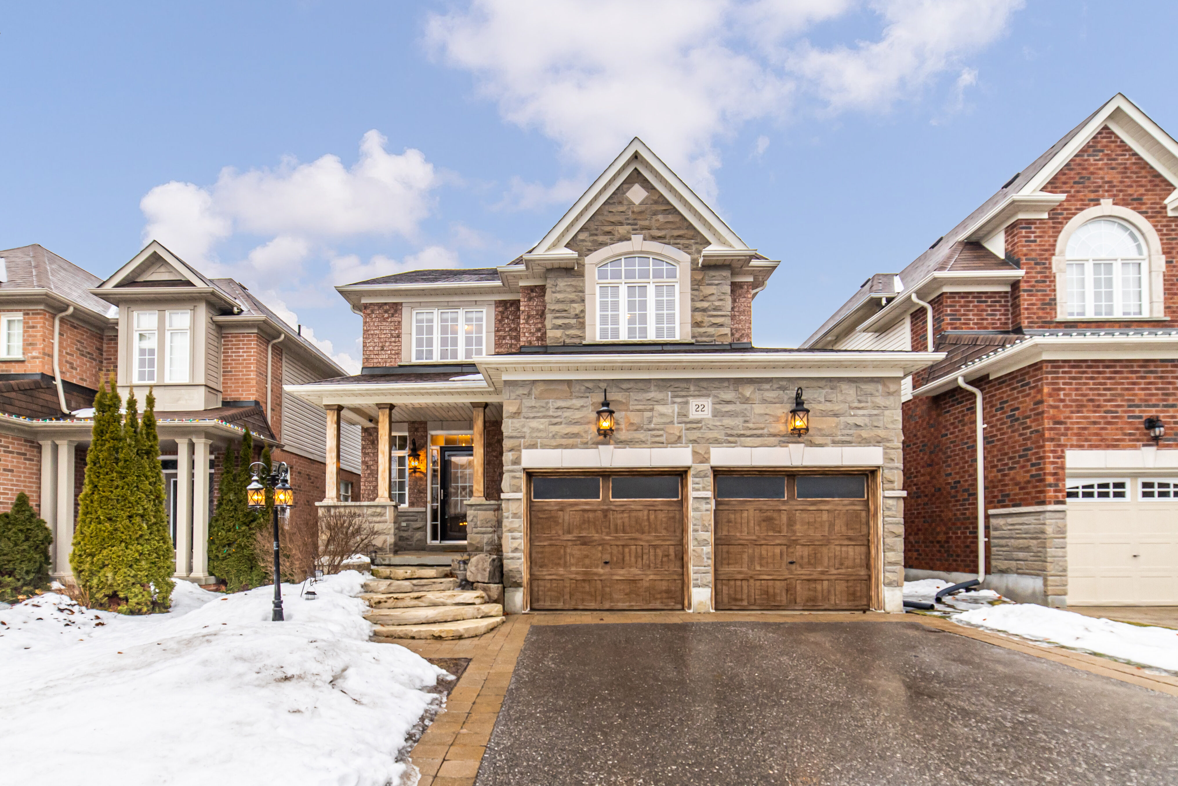 Detached Bowmanville home with two wood-look garage doors