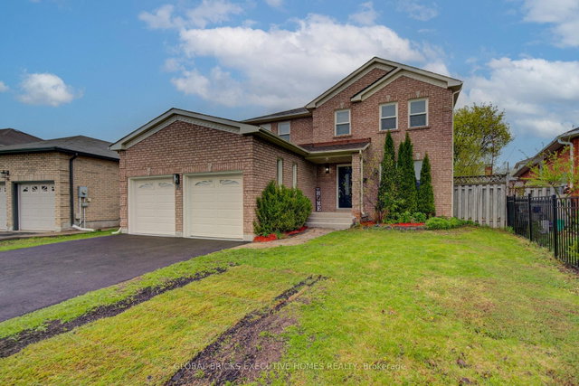 Detached Cambridge home with two cream garage doors
