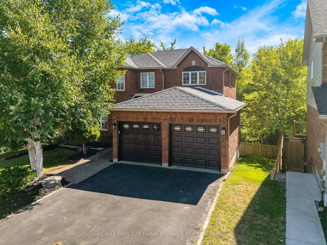 Detached Cambridge home with two dark garage doors