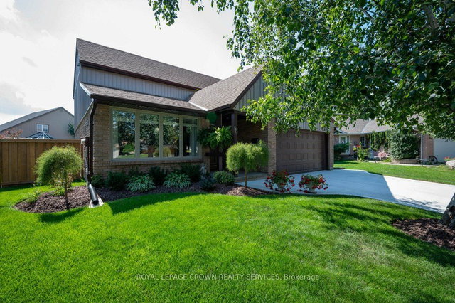 Detached Cambridge home with two white garage doors