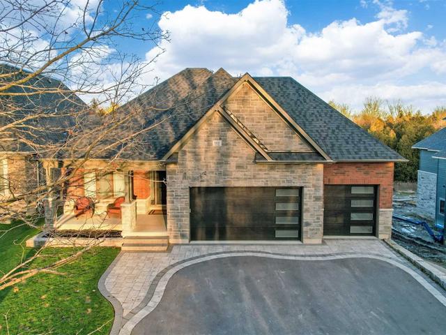 Detached Courtice bungalow with a dark garage door