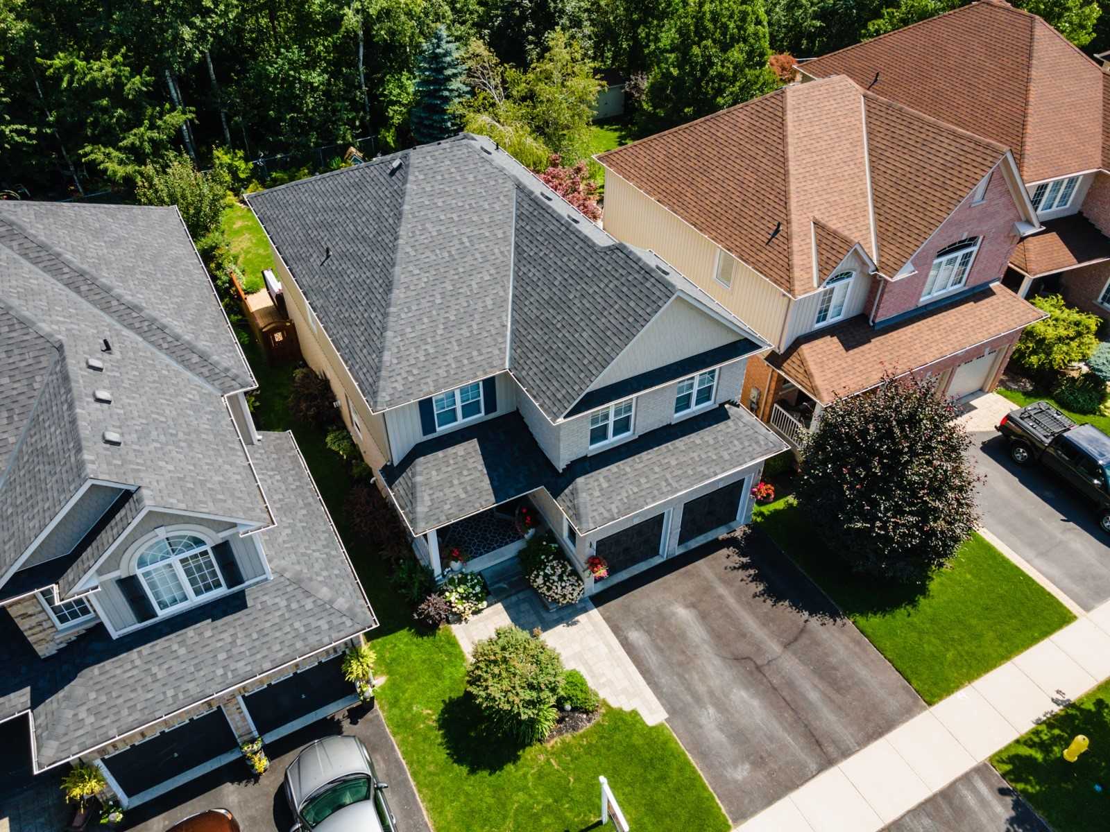 Detached Courtice home with two dark garage doors