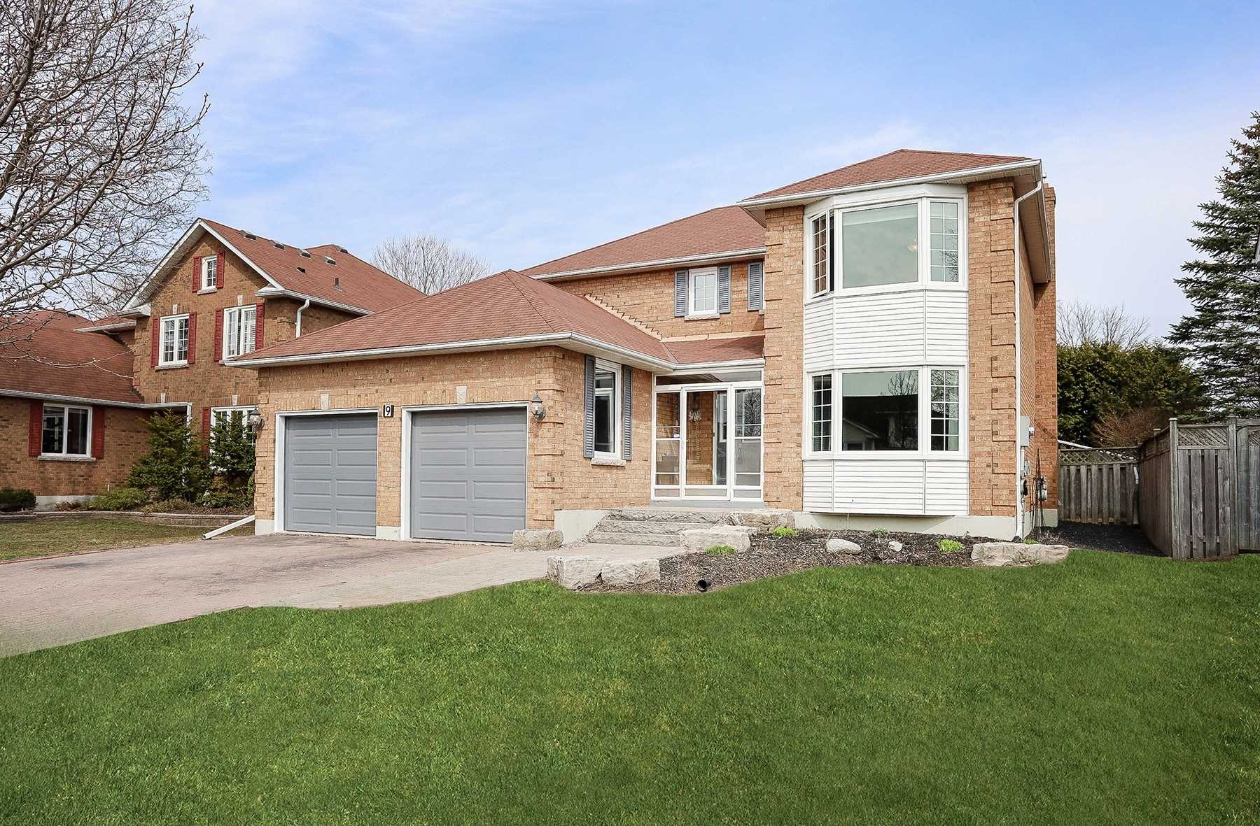 Detached Courtice home with two grey garage doors