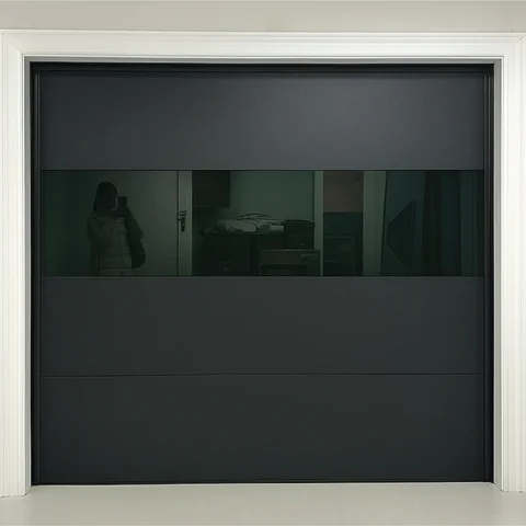 Single black garage door with a wide band of dark glass