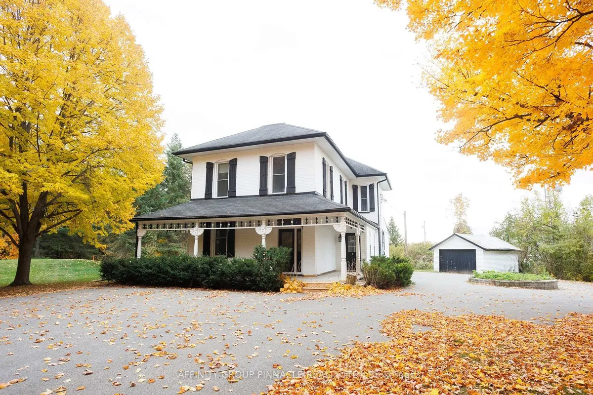 Detached Kawartha Lakes home with visible garage and broad driveway