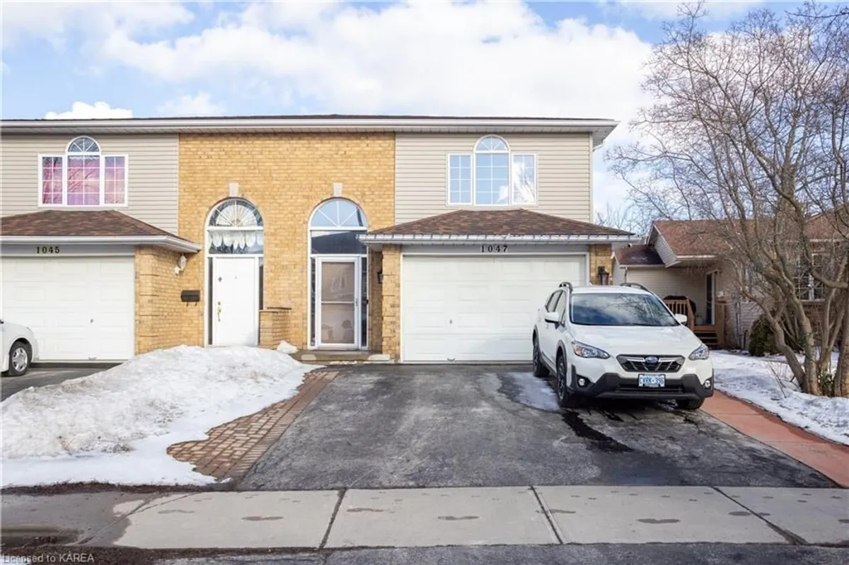 Detached Kingston home with garage door facing the driveway