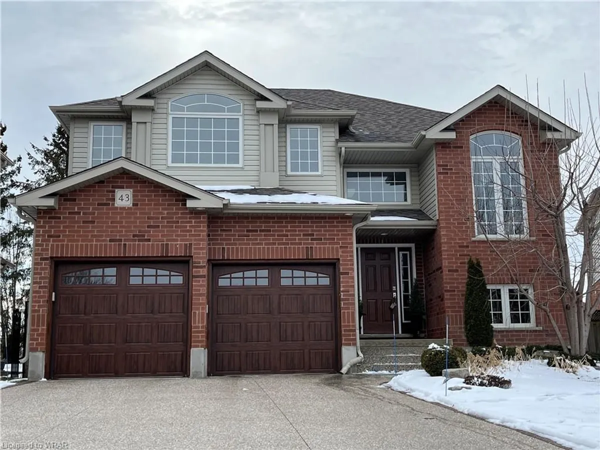 Detached Kitchener home with two brown garage doors