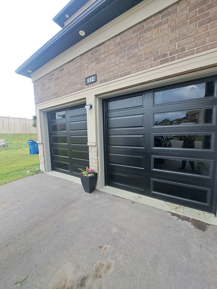 Black double garage door with contemporary glass sections