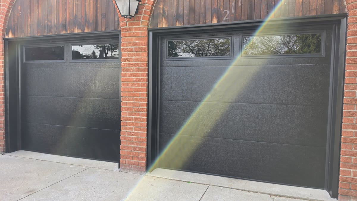 Black single garage door with a full-width glass panel