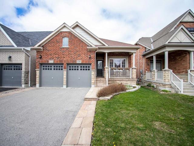 Detached Oshawa bungalow with two grey garage doors