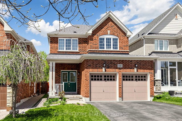 Detached Oshawa home with two tan garage doors
