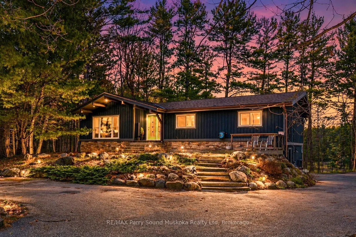 Detached Parry Sound home with visible garage driveway frontage