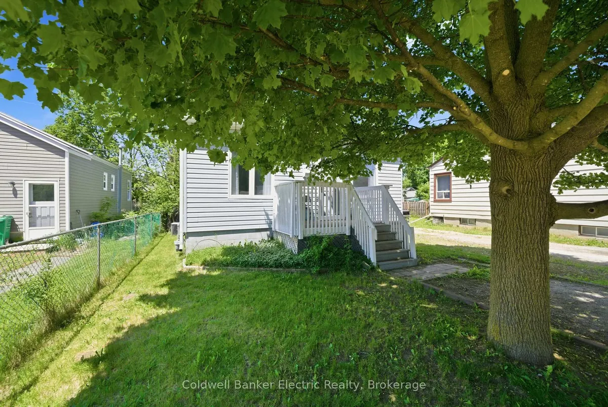 Detached Peterborough home with garage along a residential street