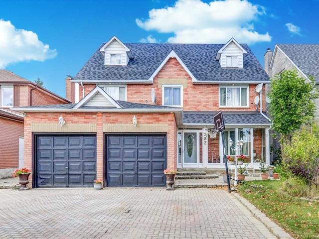 Detached Pickering home with two dark garage doors