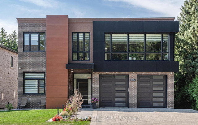 Modern detached Pickering home with two black garage doors