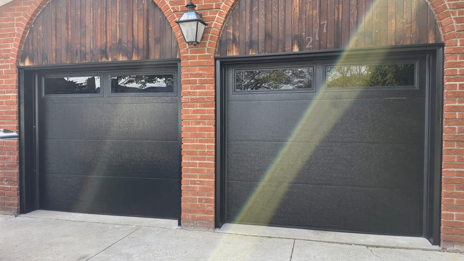 After RedOak garage door replacement with modern black garage doors and upper windows