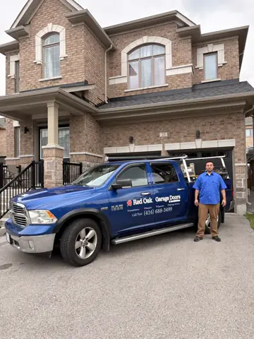 RedOak service truck and technician outside a completed garage door installation