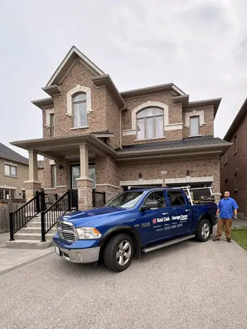 RedOak service truck and technician outside a brick home